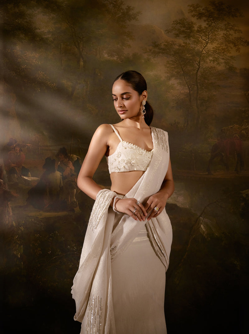 "Aartika Off-White Embroidered Saree: Elegant off-white saree with exquisite embroidery for a timeless and graceful appearance."