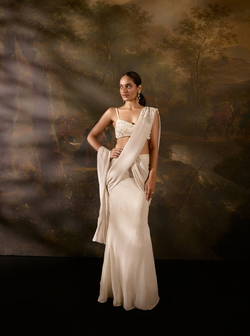 "Aartika Off-White Embroidered Saree: Elegant off-white saree with exquisite embroidery for a timeless and graceful appearance."