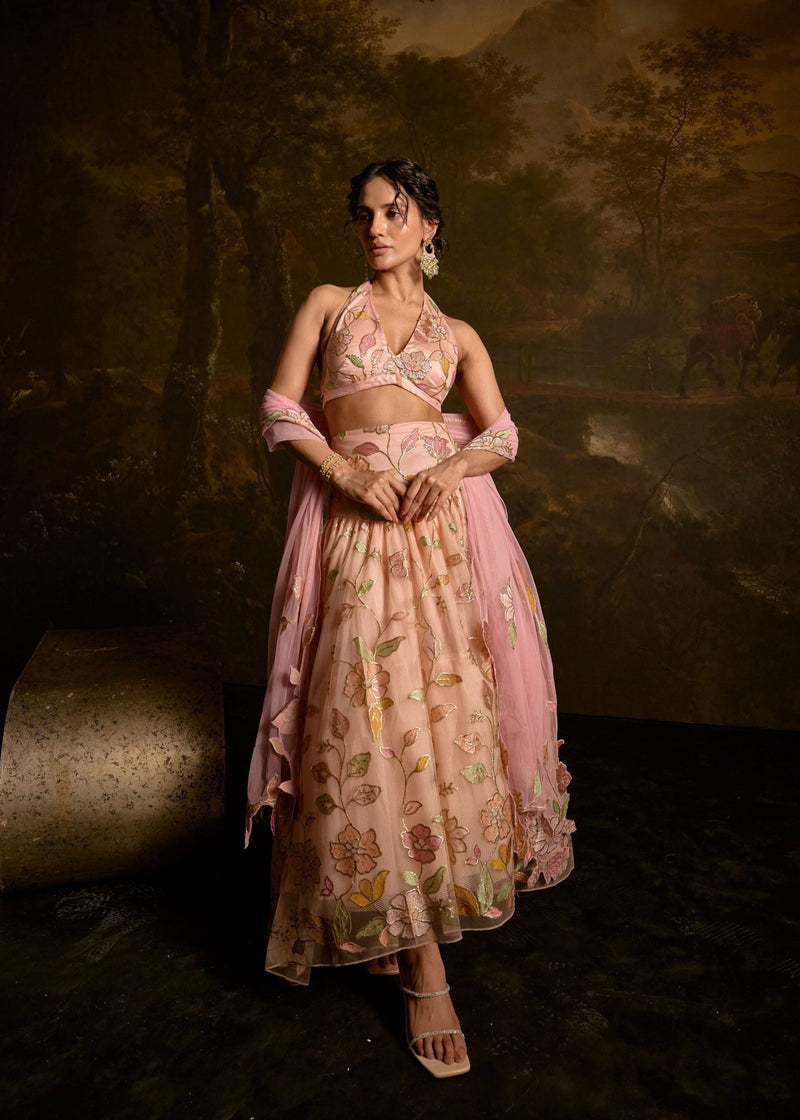 Adishri Peach Halter-Neck Embroidered Lehenga with elegant floral patterns and shimmering embellishments