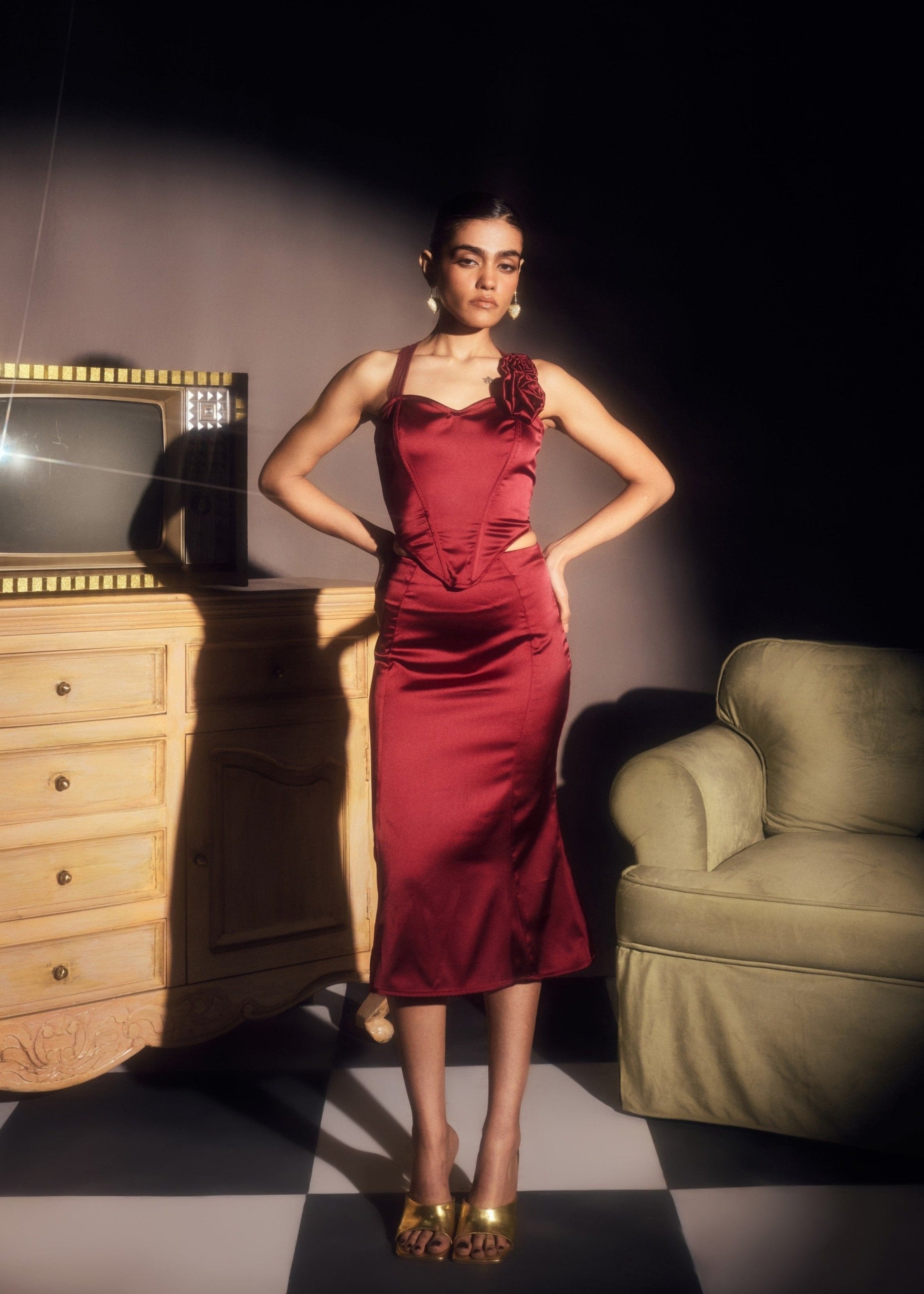 Alina Burgundy Stretch Satin Corset and Midi Skirt Set, offering a sleek satin finish with a chic corset and midi skirt combination