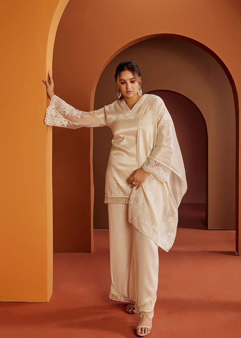 Baani Off-White Embroidered Kurta Set featuring detailed embroidery on a classic off-white fabric for a timeless and elegant style