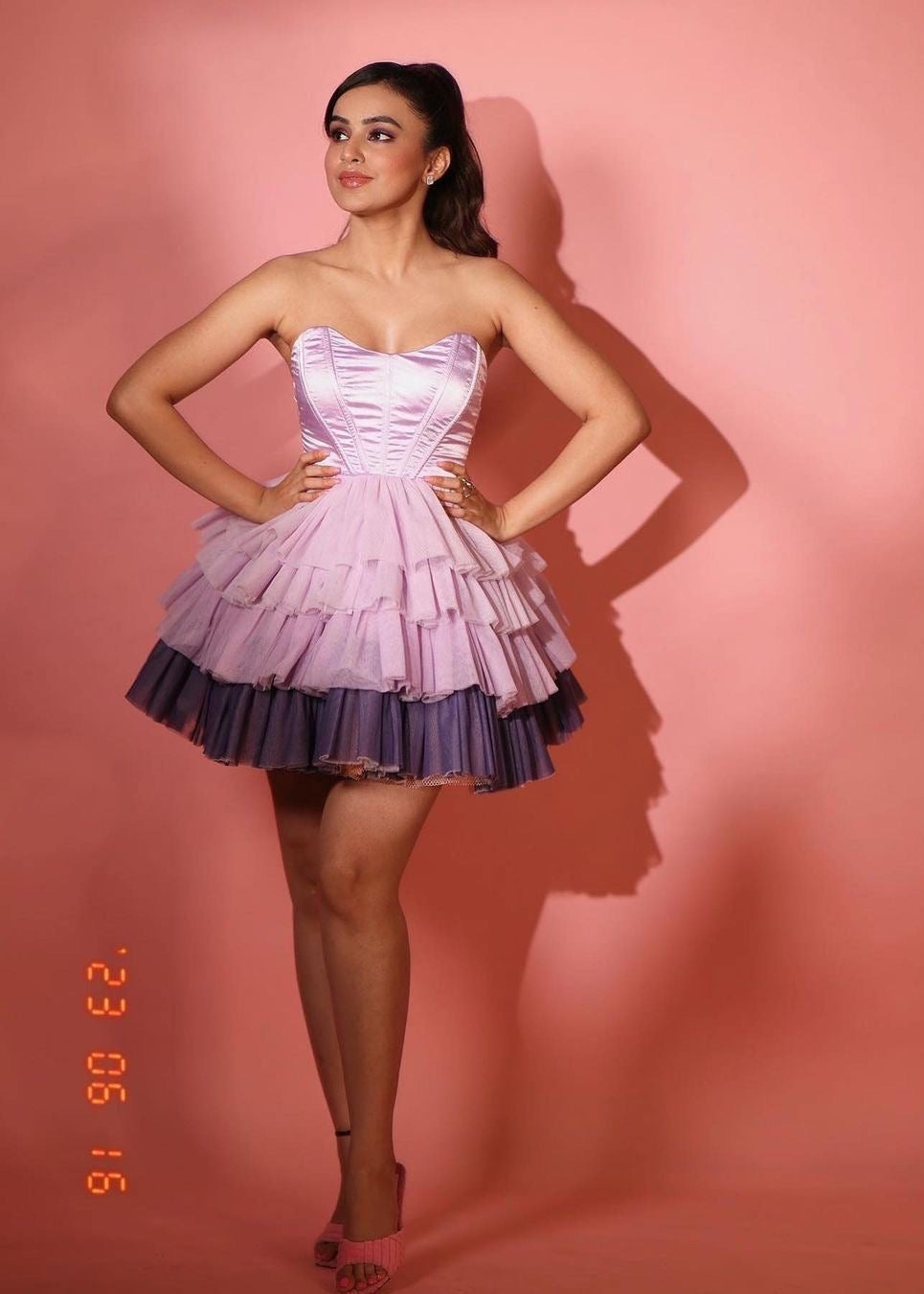 Graceful woman in a Belle Lavender Ombre Ruffle Tulle Corset Dress, showcasing ethereal beauty