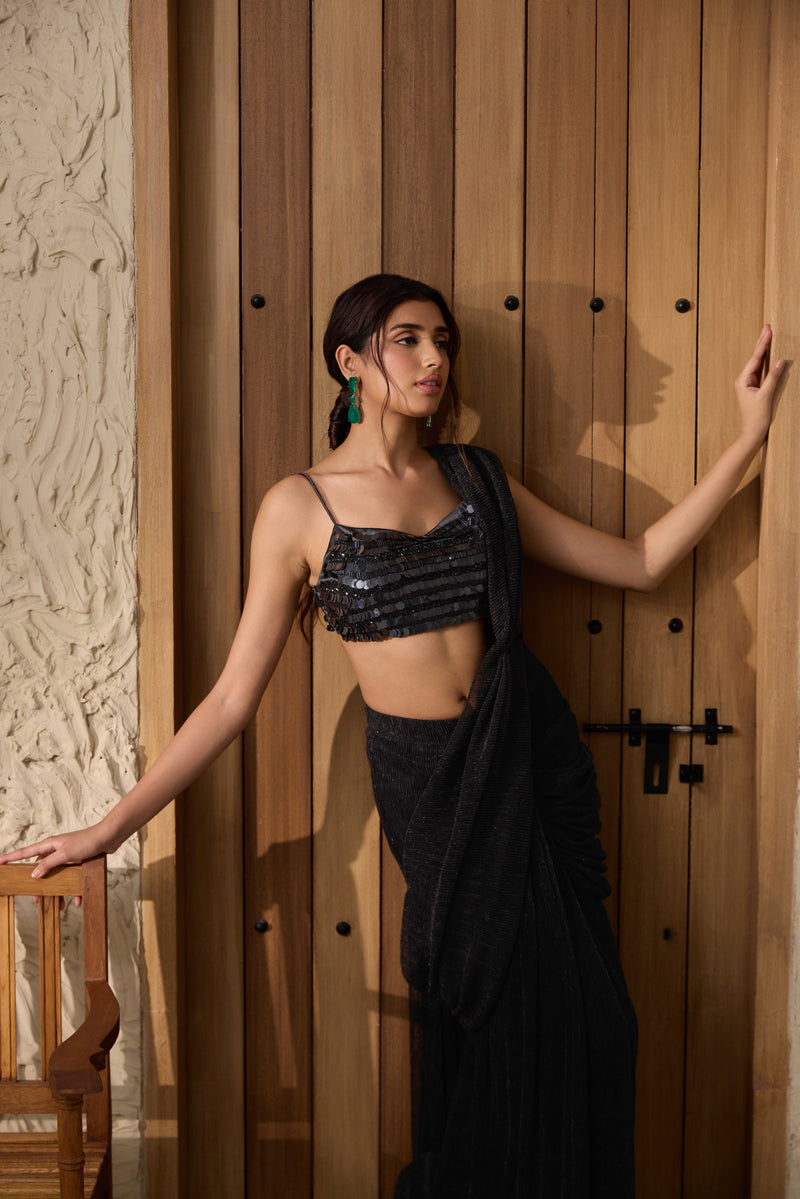 A black shimmer pre-draped saree set.