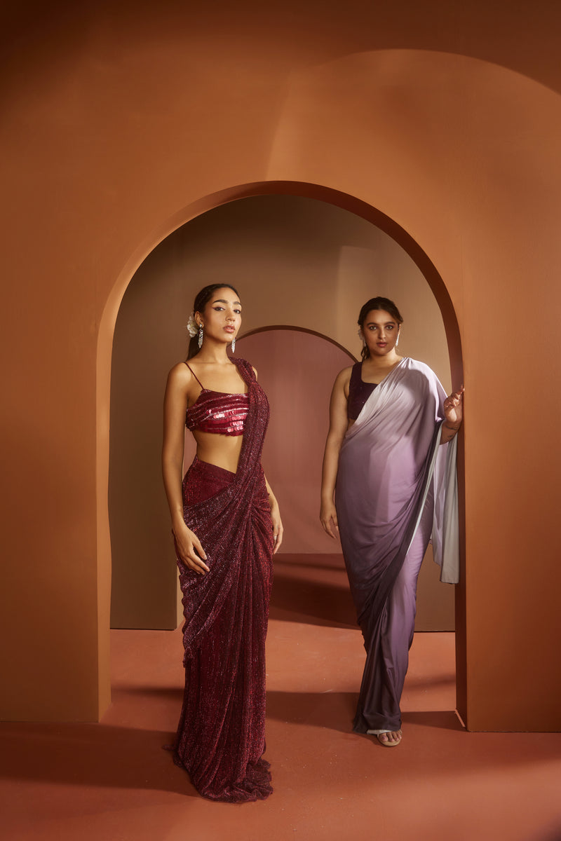 Chic woman in a Humaida Maroon Shimmer Pre-Draped Saree Set, exuding vibrant elegance