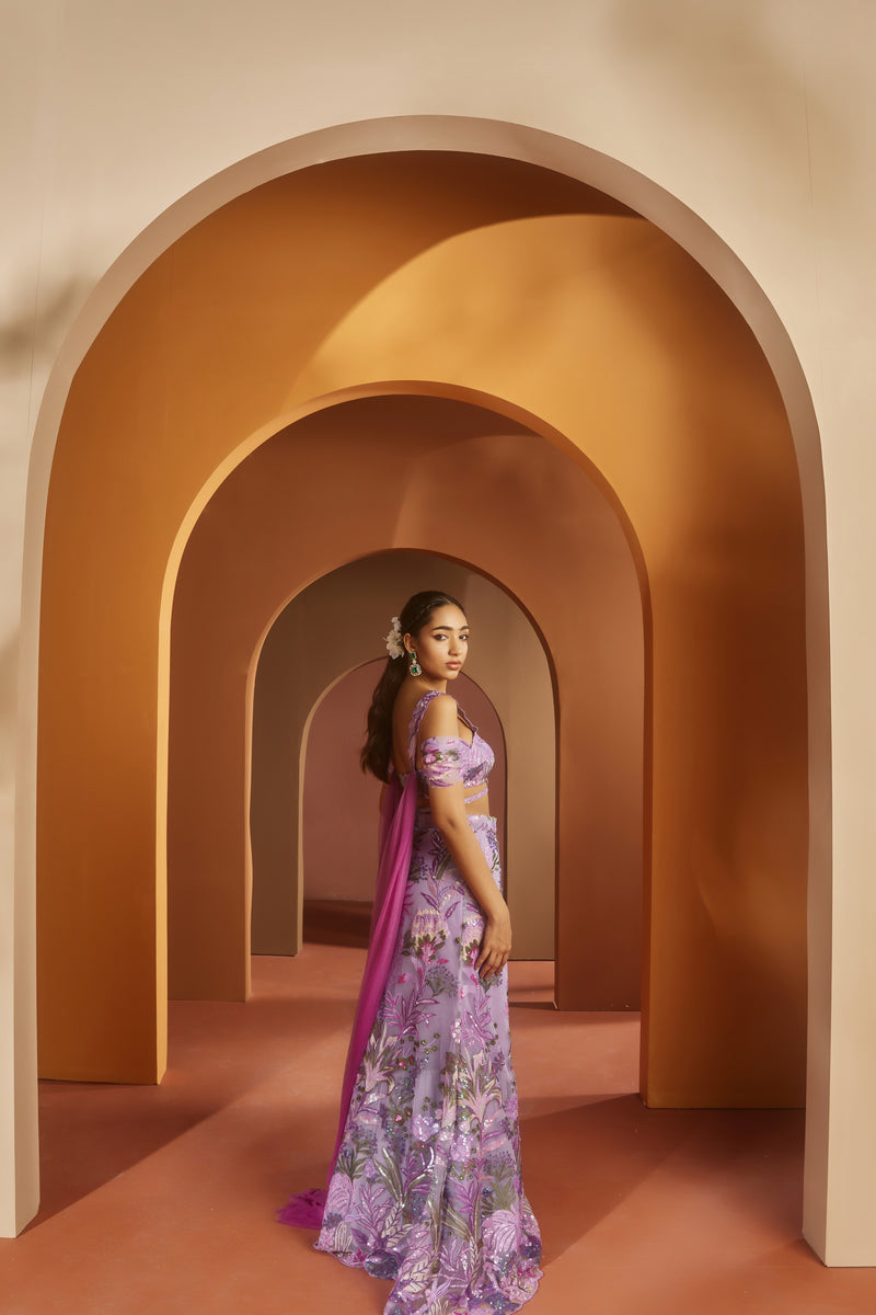 Elegant woman in a Maheen Purple Floral Sequin Lehenga, radiating regal beauty