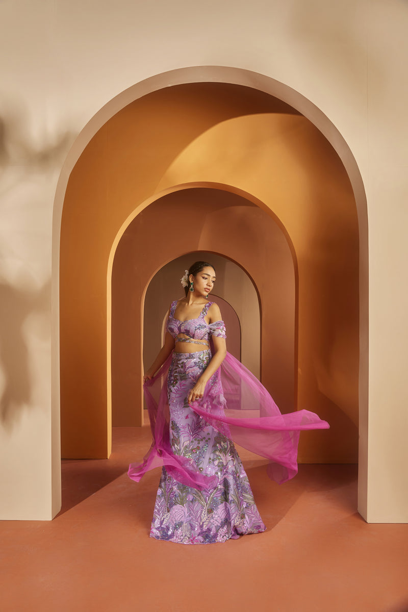 Elegant woman in a Maheen Purple Floral Sequin Lehenga, radiating regal beauty