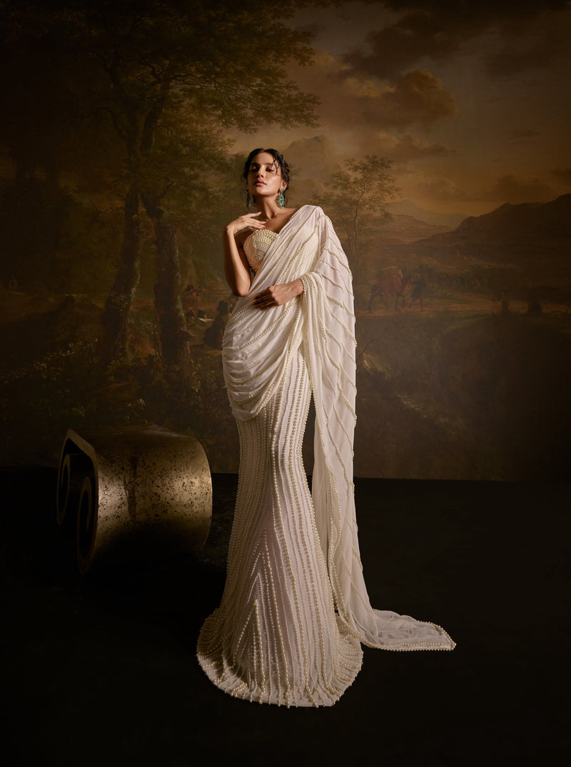 "Mahima White Pearl Embroidered Saree: White saree adorned with delicate pearl embroidery for an elegant and sophisticated look."