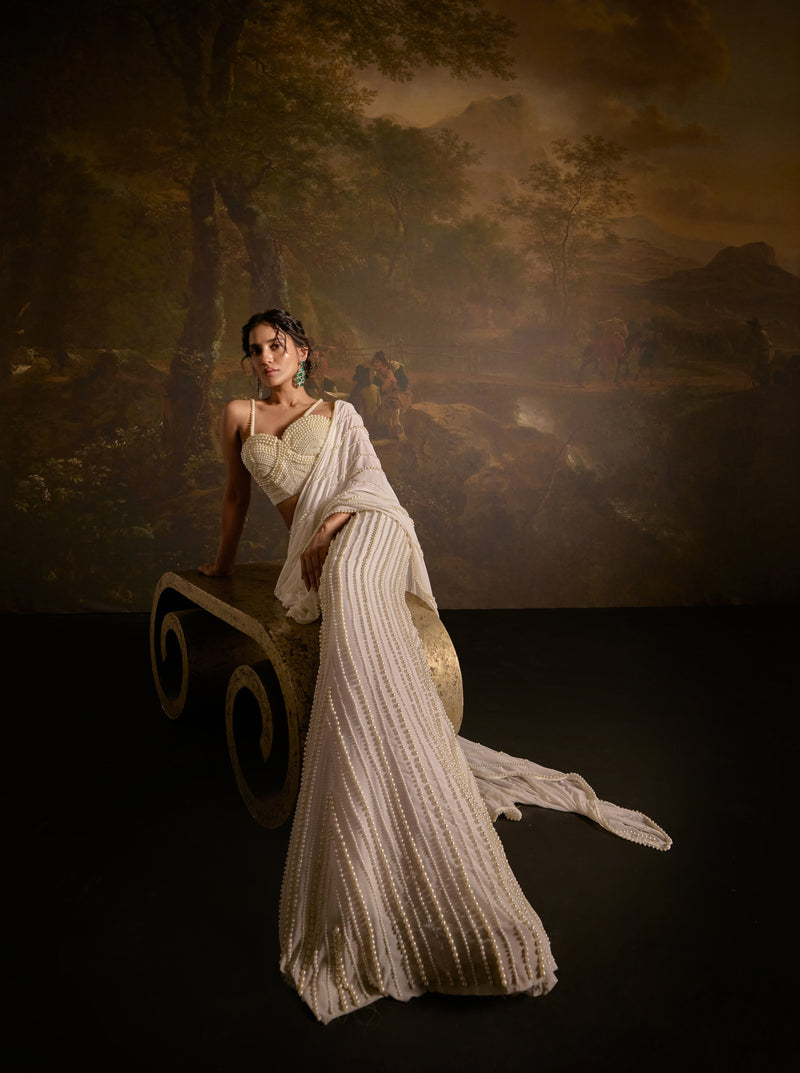 "Mahima White Pearl Embroidered Saree: White saree adorned with delicate pearl embroidery for an elegant and sophisticated look."