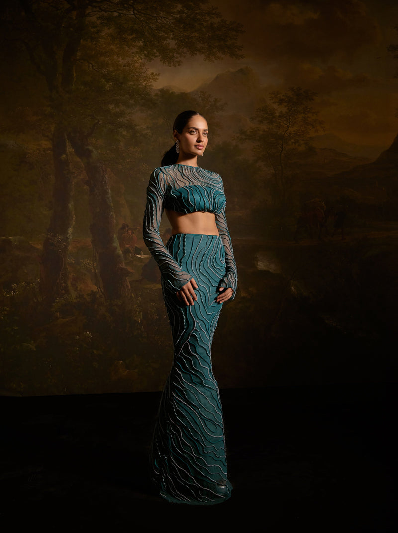 "Meera Teal Embroidered Lehenga Set: Teal lehenga set with intricate embroidery for a graceful and traditional appearance."