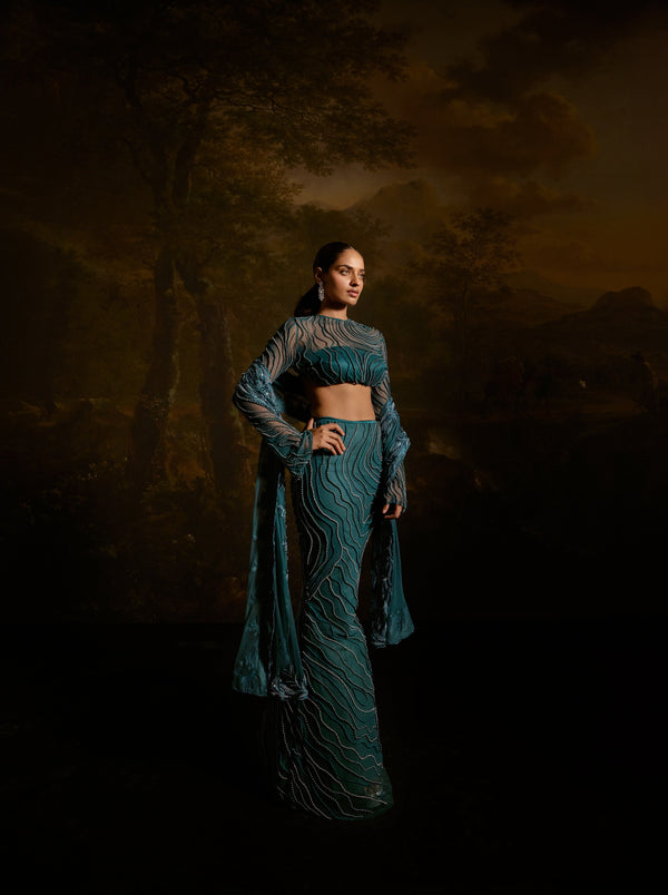 "Meera Teal Embroidered Lehenga Set: Teal lehenga set with intricate embroidery for a graceful and traditional appearance."