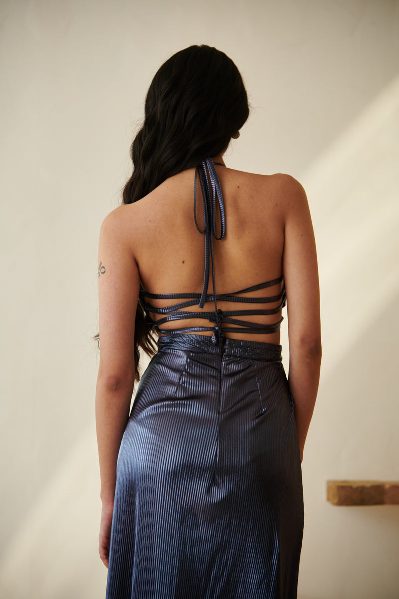 Elegant woman in a Moana Navy Blue Metallic Maxi Dress posing gracefully