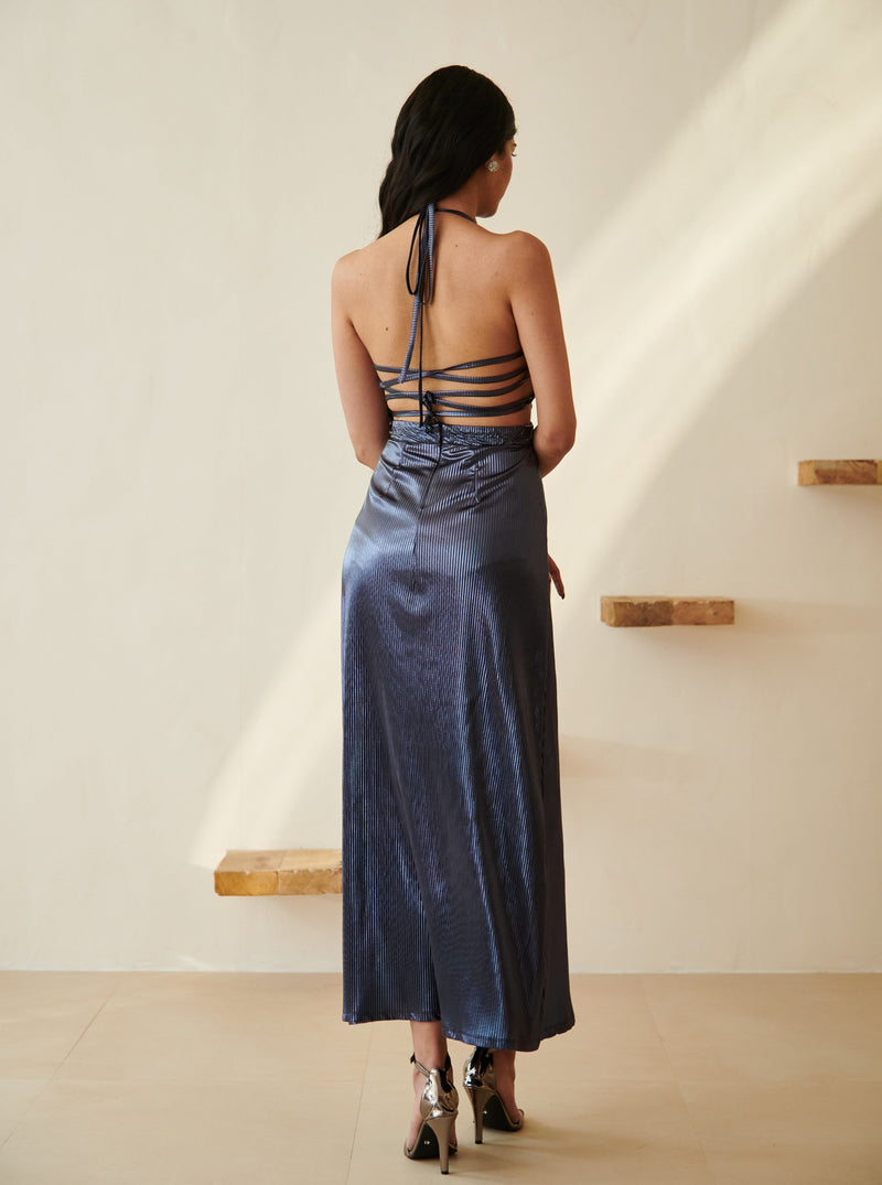 Elegant woman in a Moana Navy Blue Metallic Maxi Dress posing gracefully