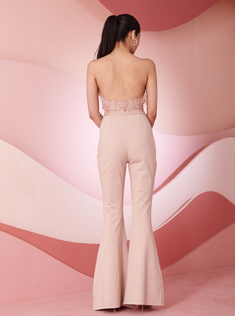 Stylish woman in a Naida Blush Hand Embroidered Corset Jumpsuit showcasing intricate detailing