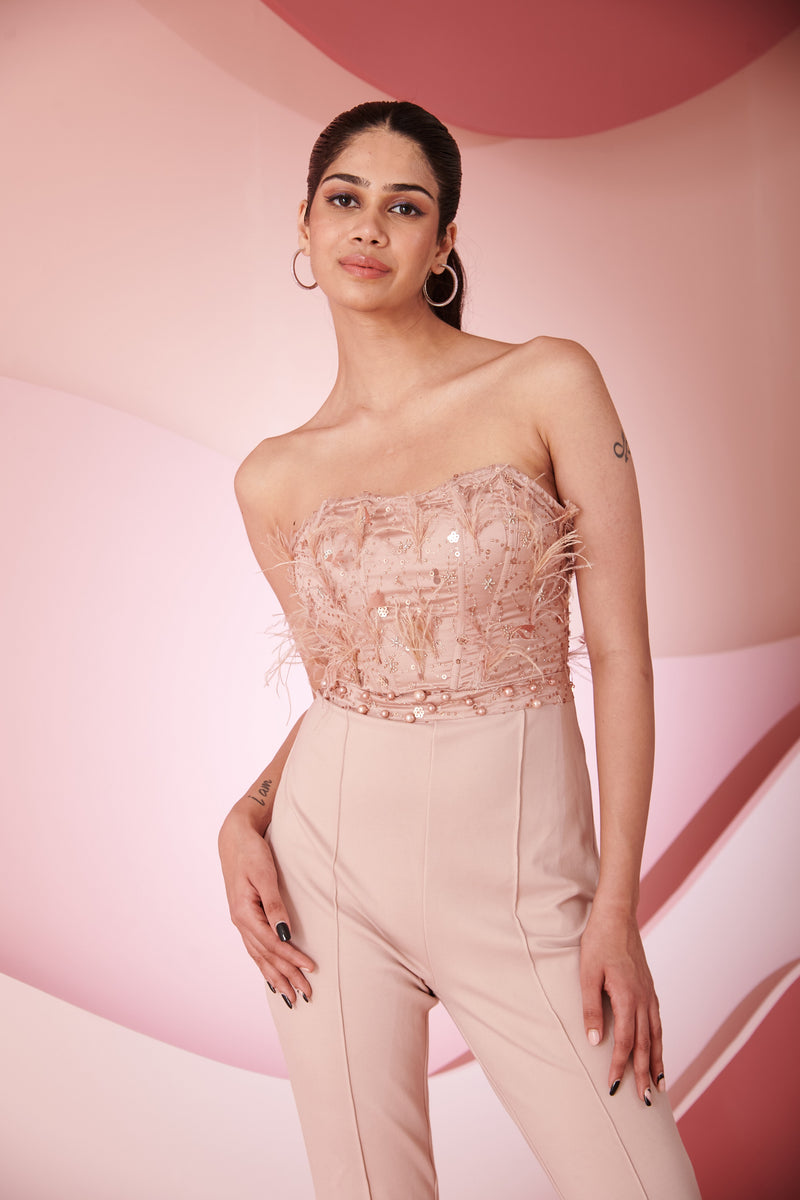 Stylish woman in a Naida Blush Hand Embroidered Corset Jumpsuit showcasing intricate detailing