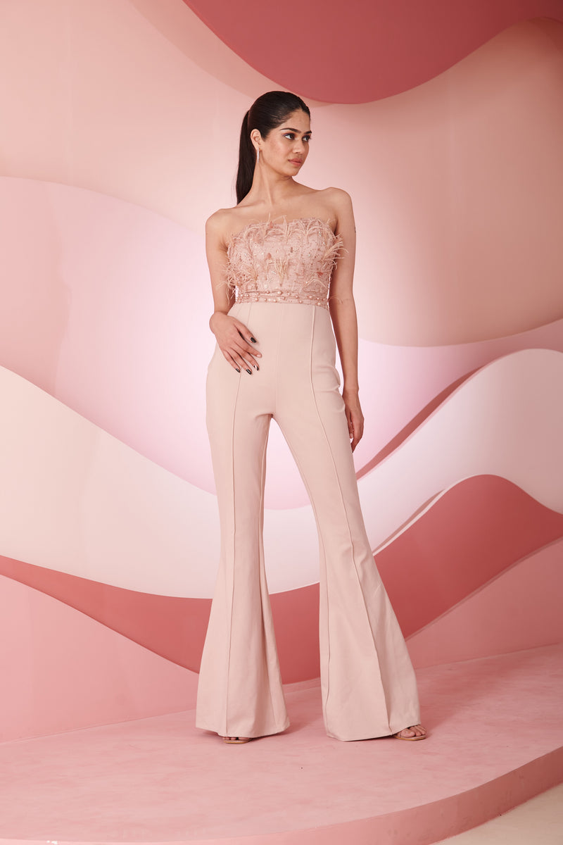 Stylish woman in a Naida Blush Hand Embroidered Corset Jumpsuit showcasing intricate detailing