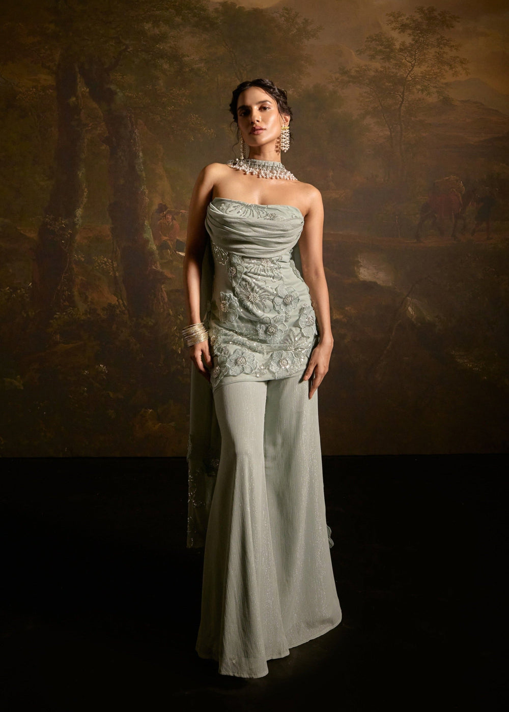 "Nakhat Sage Green 3D Flower Embroidered Sleeveless Sharara Set: Stylish sleeveless sharara set in sage green, adorned with intricate 3D flower embroidery for a unique and elegant look."