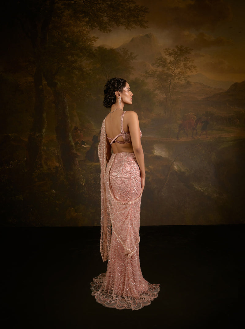 "Niyati Blush Pink Embellished Saree: Blush pink saree with intricate embellishments for a luxurious and elegant look."