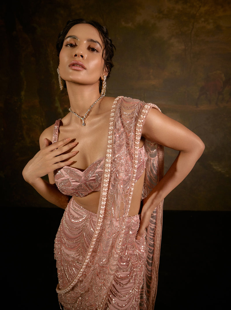 "Niyati Blush Pink Embellished Saree: Blush pink saree with intricate embellishments for a luxurious and elegant look."