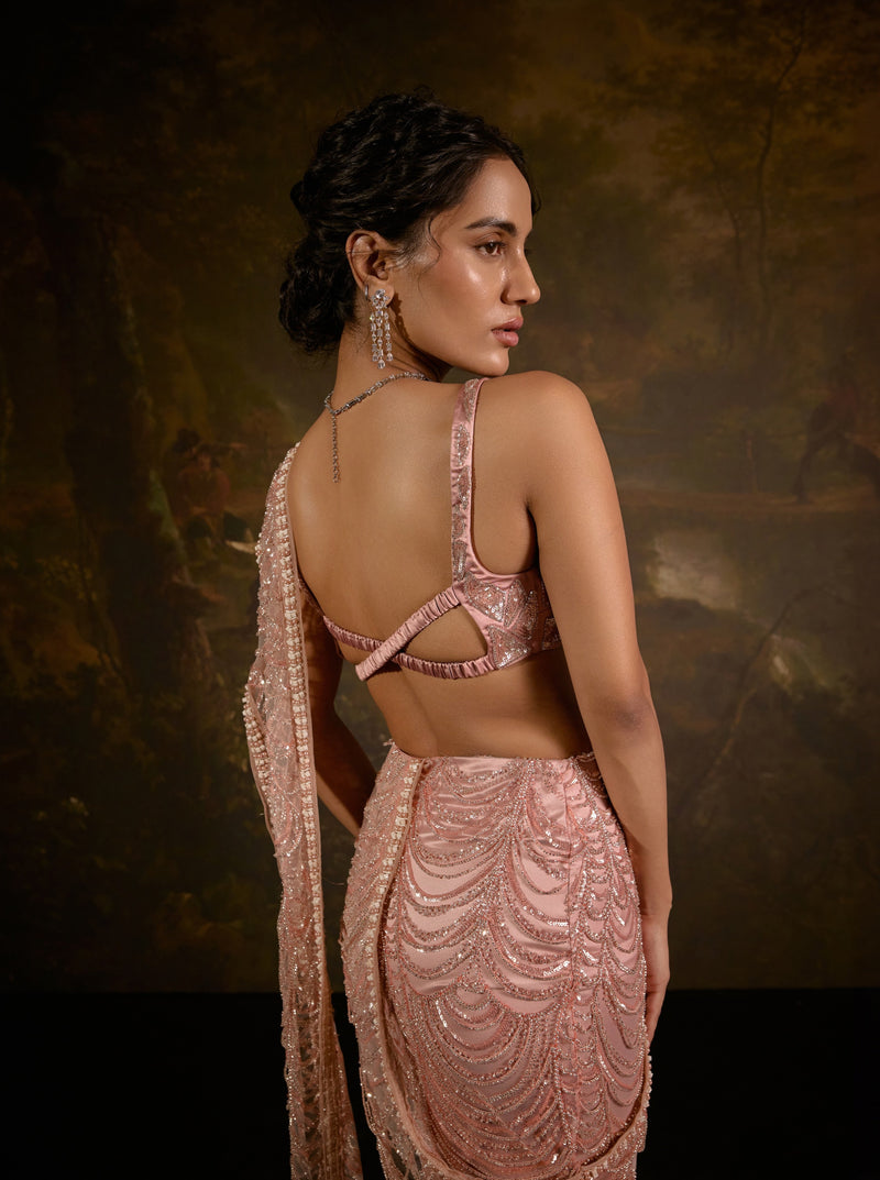 "Niyati Blush Pink Embellished Saree: Blush pink saree with intricate embellishments for a luxurious and elegant look."