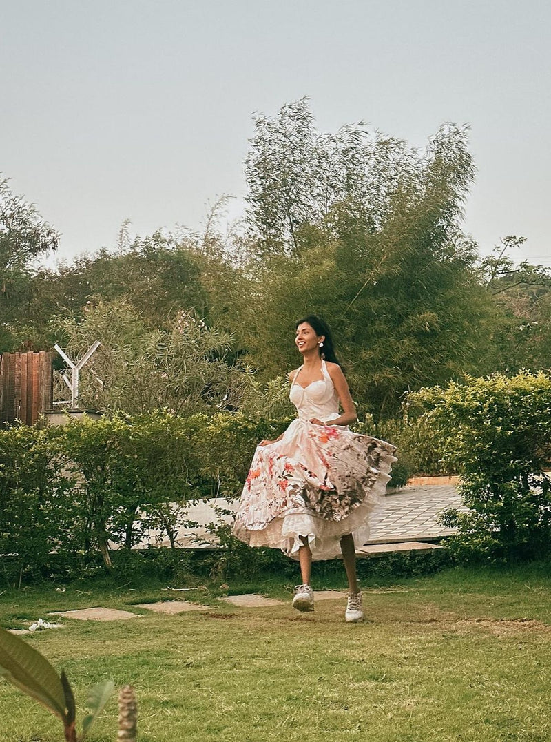 Oaklynn White Floral Corset Halter Midi Dress featuring a fitted bodice and flowy skirt adorned with delicate floral patterns