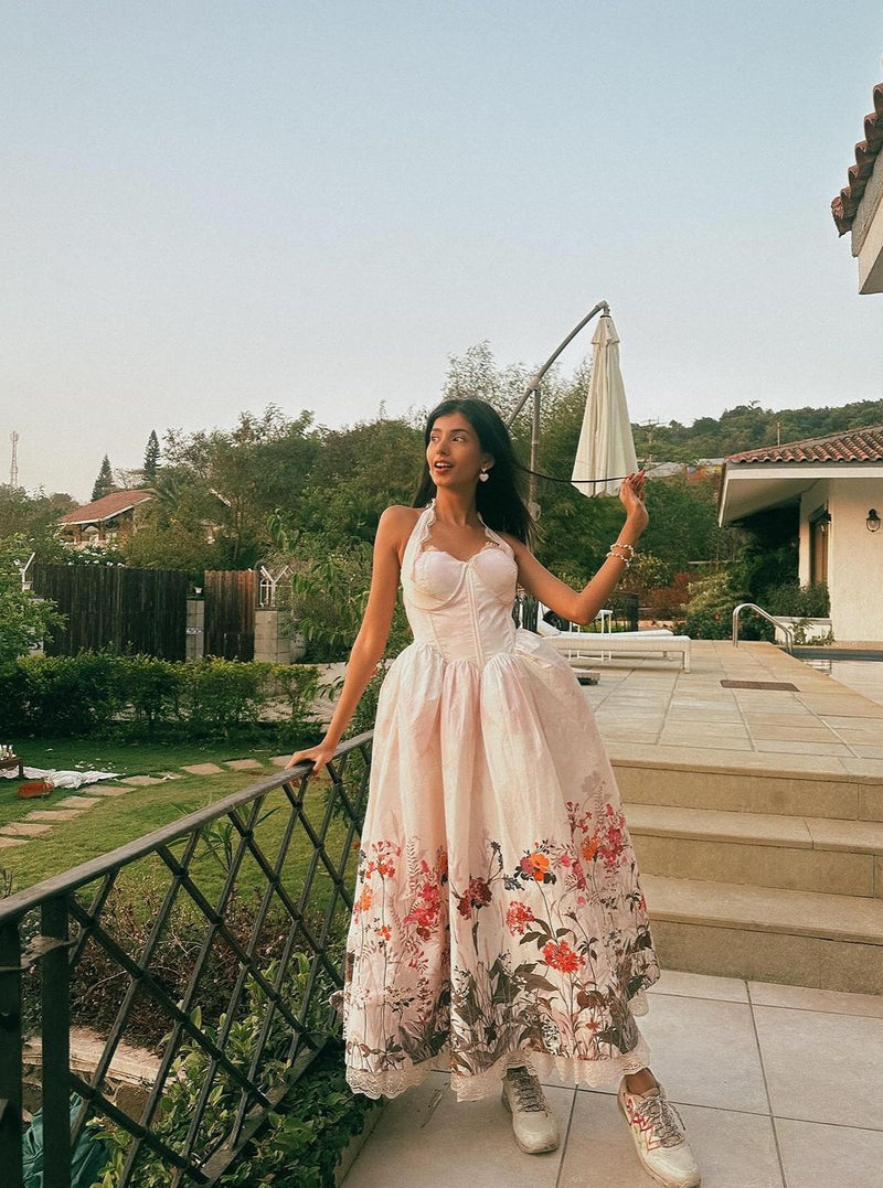 Oaklynn White Floral Corset Halter Midi Dress featuring a fitted bodice and flowy skirt adorned with delicate floral patterns