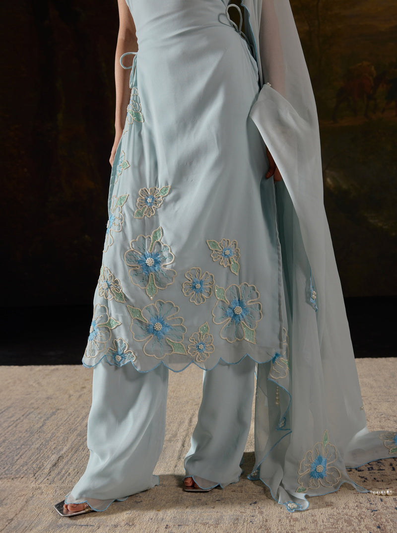 Raaya Baby Blue Hand-Embroidered Sleeveless Suit featuring intricate floral designs and lightweight fabric."