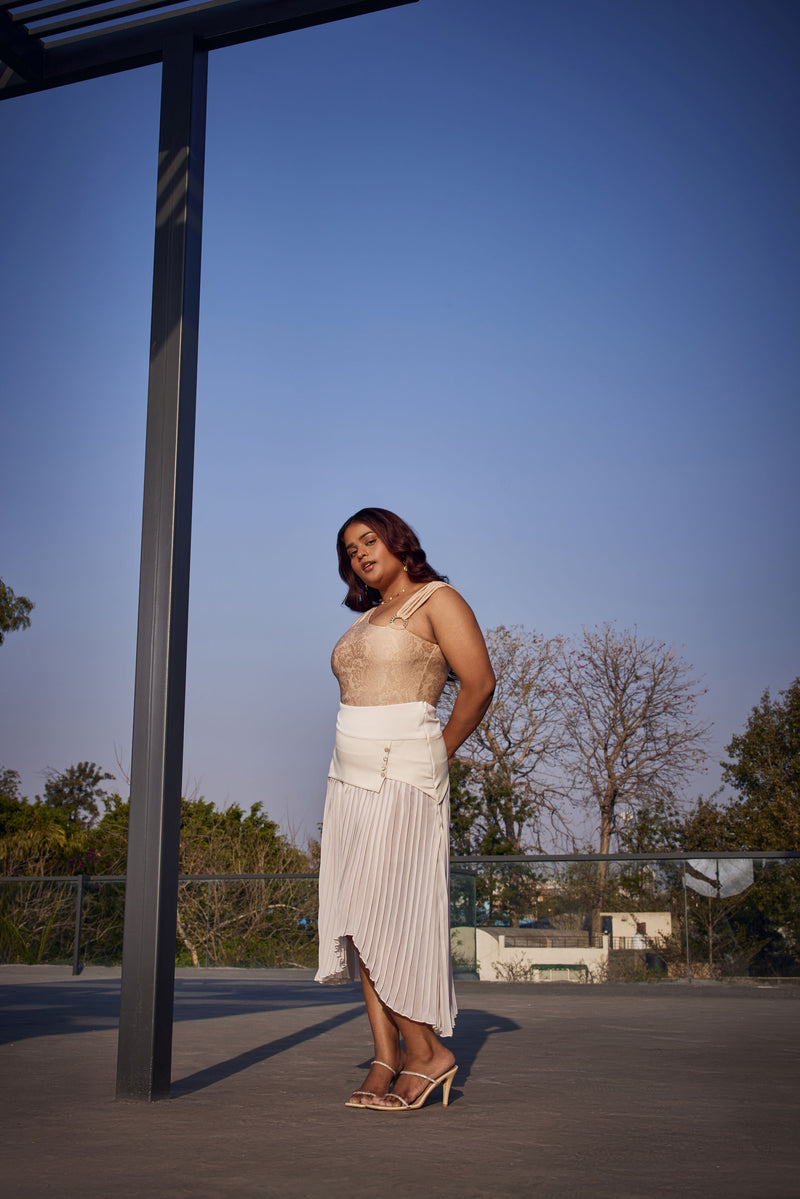 "Raegan Gold Asymmetric Bodysuit and White Pleated Maxi Skirt with a Contemporary Flair."