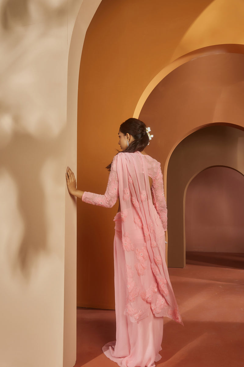 Graceful woman in a Sarika Pink Flower Embroidery Pre-Draped Saree Set, radiating floral elegance and charm