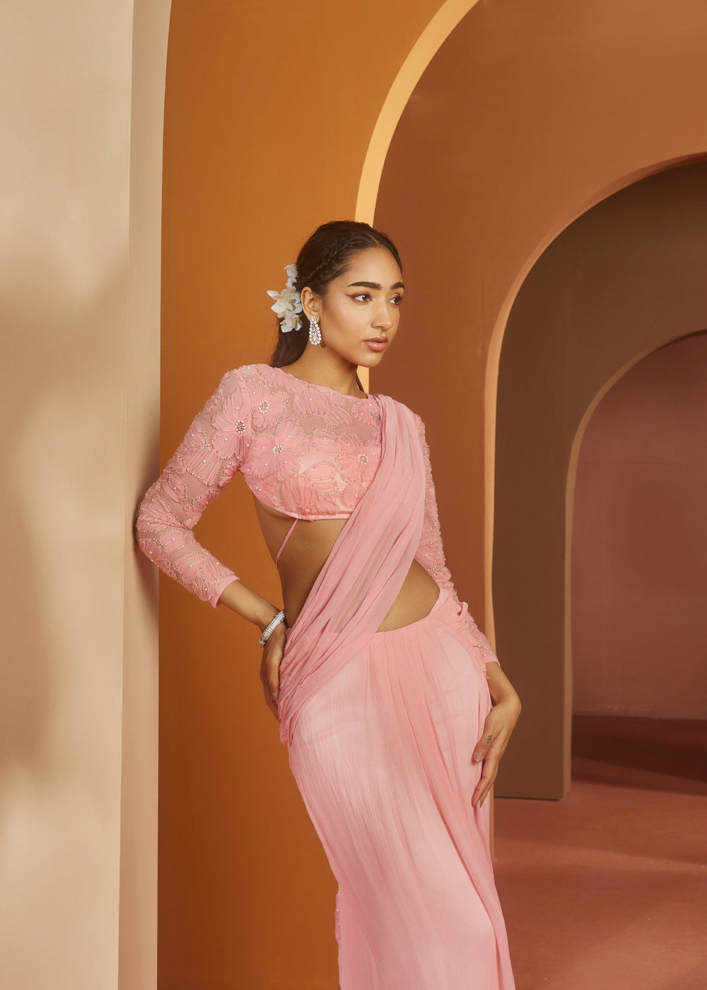Graceful woman in a Sarika Pink Flower Embroidery Pre-Draped Saree Set, radiating floral elegance and charm