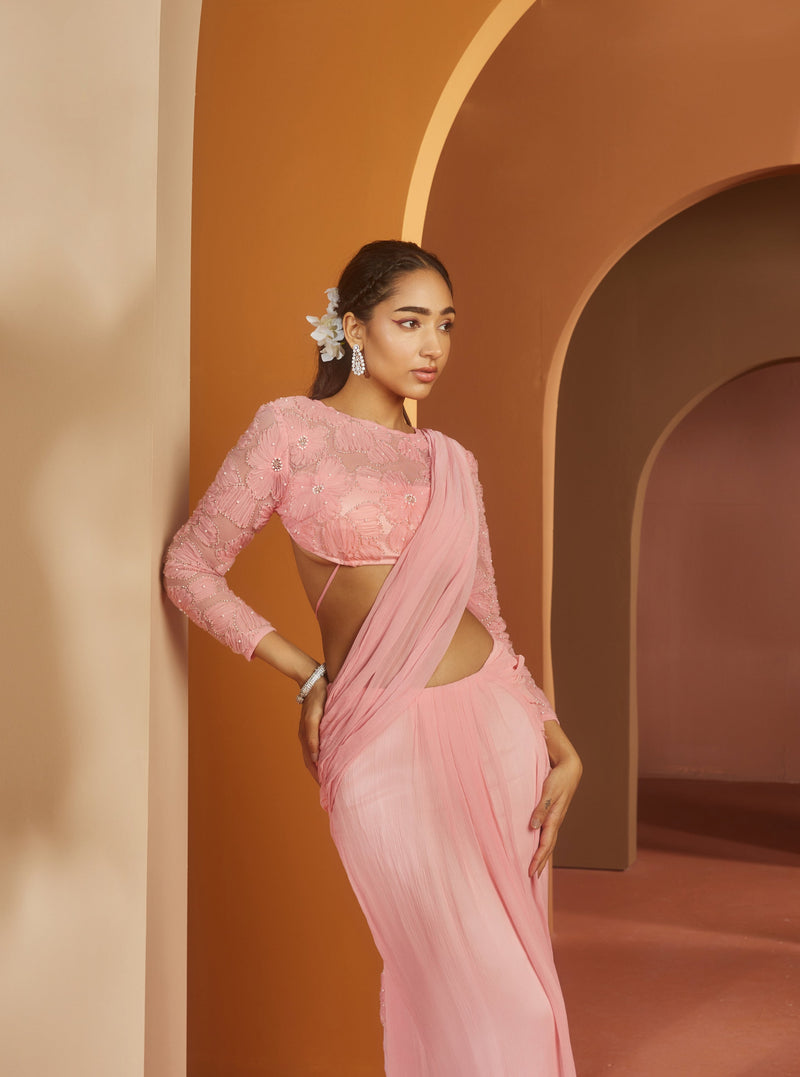 Graceful woman in a Sarika Pink Flower Embroidery Pre-Draped Saree Set, radiating floral elegance and charm