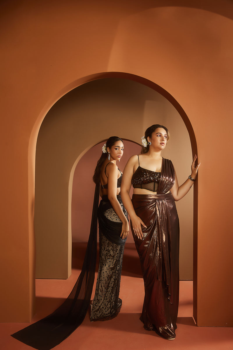 Elegant woman in a Shereen Black and Nude Embroidered Pre-Draped Saree Set, exuding timeless sophistication