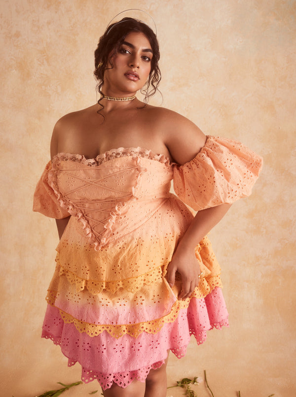 Stevie Sunset Ombre Schiffli Ruffled Corset Mini Dress, featuring a gradient sunset ombre design with Schiffli embroidery and ruffled details.