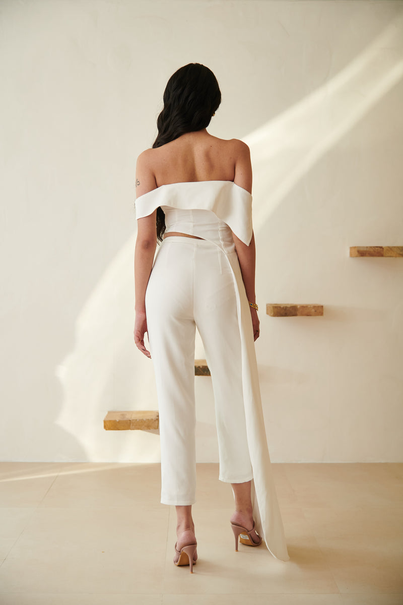 Stylish woman in a Tamara White Asymmetric Top and Pants Set, showcasing modern sophistication