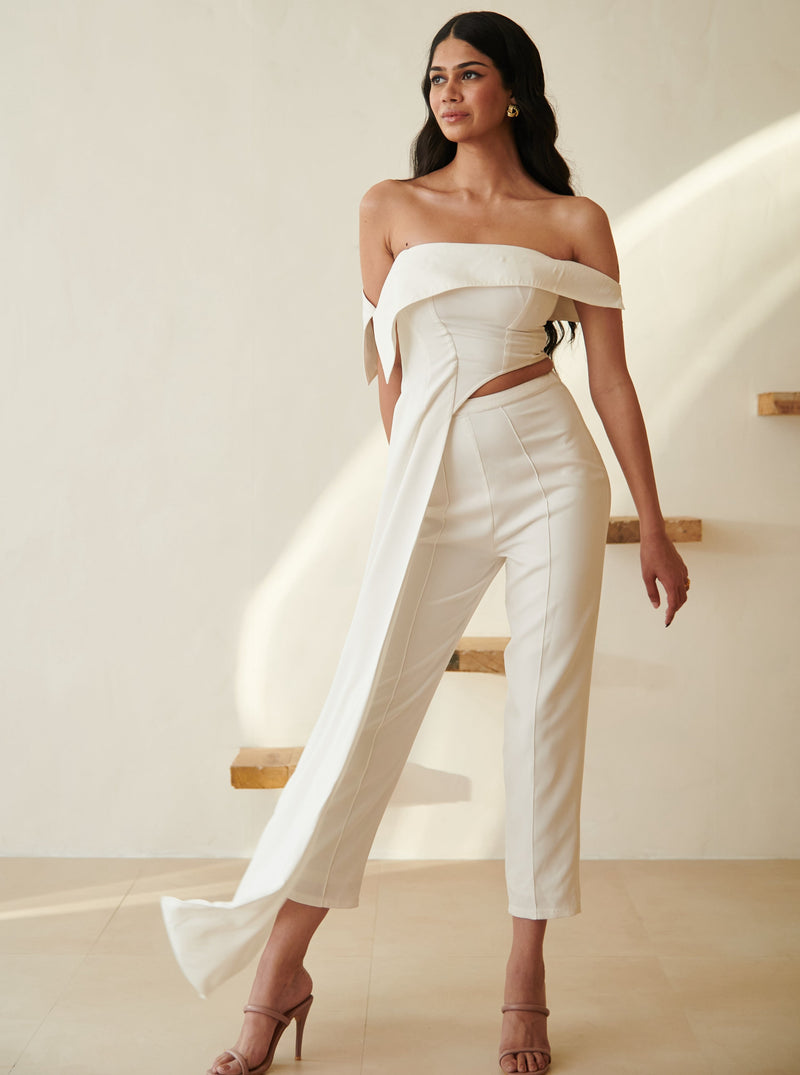 Stylish woman in a Tamara White Asymmetric Top and Pants Set, showcasing modern sophistication