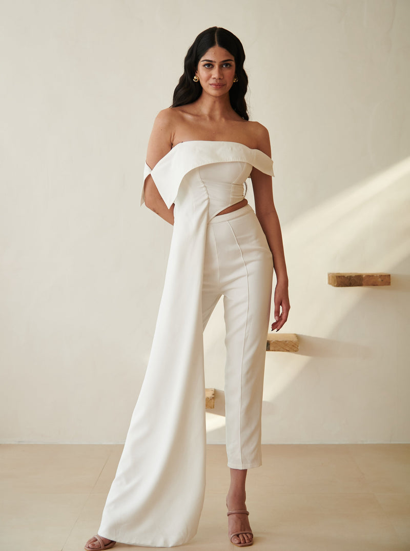 Stylish woman in a Tamara White Asymmetric Top and Pants Set, showcasing modern sophistication