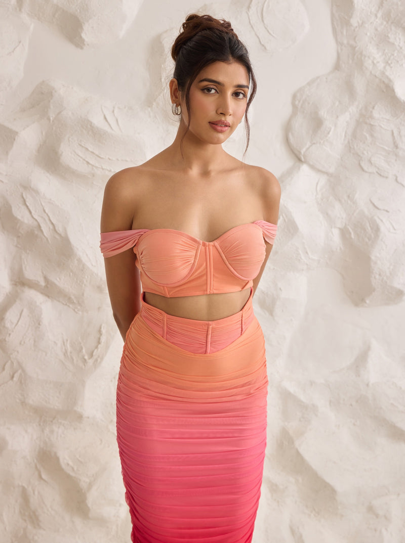 A striking Tatiana sunset ombre midi corset dress with ruched detailing for a flattering silhouette.