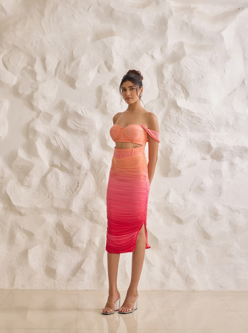 A striking Tatiana sunset ombre midi corset dress with ruched detailing for a flattering silhouette.