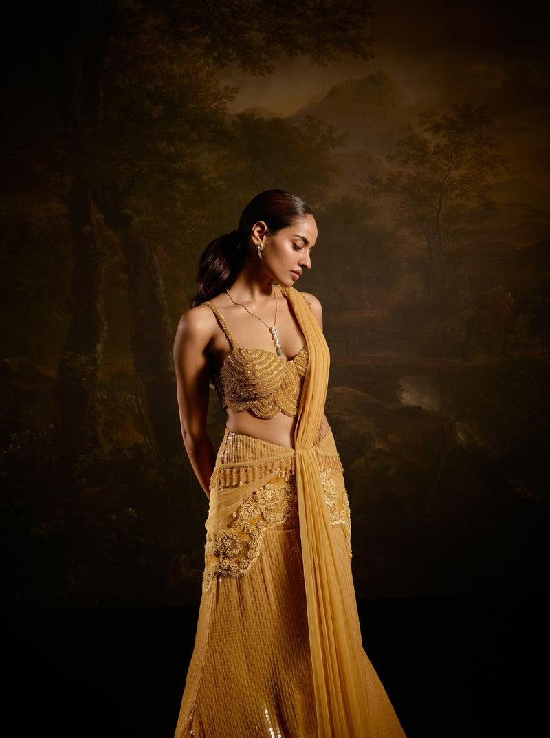 "Yashvi Gold Embroidered Saree: Opulent gold saree with intricate embroidery for a regal and luxurious appearance."