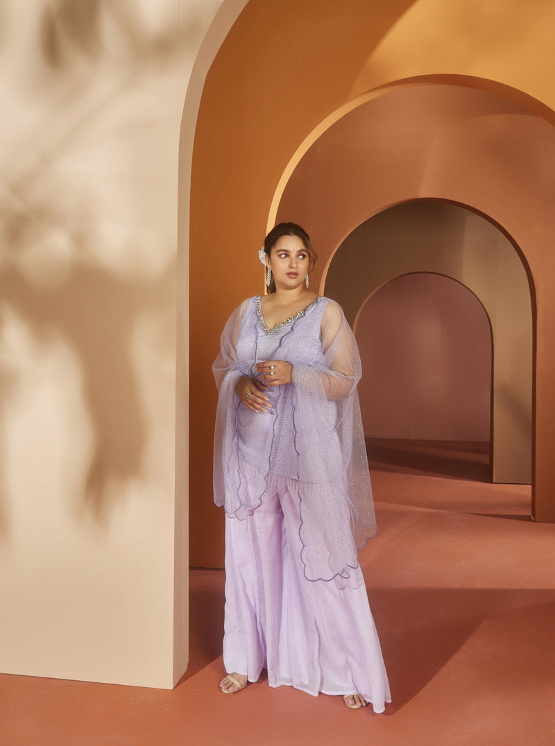 Elegant woman in a Zivah Lavender Shimmer Kurta Set, exuding a subtle, radiant charm